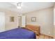 Secondary bedroom with dresser, ceiling fan, and tile floors at 3357 E Gold Dust Ave, Phoenix, AZ 85028