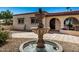 Close-up view of an ornate fountain in a beautifully landscaped courtyard at 3357 E Gold Dust Ave, Phoenix, AZ 85028