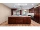 Spacious kitchen with island, stainless steel appliances, and dark wood cabinetry at 3357 E Gold Dust Ave, Phoenix, AZ 85028