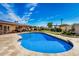 Relaxing kidney-shaped pool surrounded by a stone patio at 3357 E Gold Dust Ave, Phoenix, AZ 85028