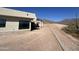 Exterior view of a modern home with large windows and a desert landscape, still under construction at 3529 S Kings Ranch Ct, Gold Canyon, AZ 85118