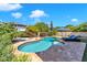 Freeform pool with stone patio and lounge chairs at 3548 E Mesquite St, Gilbert, AZ 85296