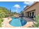 Freeform pool with stone patio and lounge chairs at 3548 E Mesquite St, Gilbert, AZ 85296