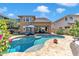 Freeform pool with stone patio and lounge chairs at 3548 E Mesquite St, Gilbert, AZ 85296