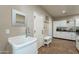 Small bathroom with a pedestal sink and built-in storage at 36080 W Merced St, Maricopa, AZ 85138