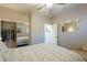 Bedroom with mirrored closet doors and patterned bedding at 36080 W Merced St, Maricopa, AZ 85138