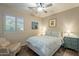 Bedroom with a ceiling fan, window shutters, and patterned bedding at 36080 W Merced St, Maricopa, AZ 85138