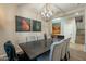 Dining room with a large chandelier and modern art at 36080 W Merced St, Maricopa, AZ 85138