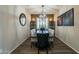 Elegant dining room with dark wood table and gray chairs at 36080 W Merced St, Maricopa, AZ 85138