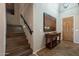 Entryway with wooden stairs, console table, and large art piece at 36080 W Merced St, Maricopa, AZ 85138