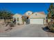 Tan house with a white garage door and desert landscaping at 36080 W Merced St, Maricopa, AZ 85138