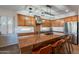 Kitchen with large island, stainless steel appliances and wood cabinets at 36080 W Merced St, Maricopa, AZ 85138