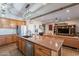 Island kitchen with granite countertops and wood cabinetry at 36080 W Merced St, Maricopa, AZ 85138