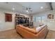 Living room with leather sectional and a rustic media center at 36080 W Merced St, Maricopa, AZ 85138