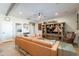 Spacious living room with a leather couch and built-in shelving at 36080 W Merced St, Maricopa, AZ 85138