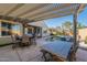 Spacious patio with seating area and pergola, perfect for al fresco dining at 36080 W Merced St, Maricopa, AZ 85138