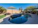 Relaxing backyard oasis with a sparkling pool, built-in spa, and covered patio at 36080 W Merced St, Maricopa, AZ 85138