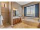 Relaxing bathroom with a soaking tub, vanity, and a walk-in shower at 42405 N Anthem Creek Dr, Anthem, AZ 85086