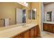 Well-lit bathroom with double sinks, a large mirror, and plenty of counter space at 42405 N Anthem Creek Dr, Anthem, AZ 85086