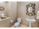 Elegant powder room with decorative mirror and pedestal sink at 42405 N Anthem Creek Dr, Anthem, AZ 85086