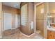 Spa-like bathroom with a walk-in shower, glass block feature wall, and tile flooring at 42405 N Anthem Creek Dr, Anthem, AZ 85086