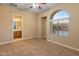 Bright bedroom with carpeting, large window, and ensuite bathroom access at 42405 N Anthem Creek Dr, Anthem, AZ 85086