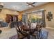 Elegant dining room with wood table and access to the living room at 42405 N Anthem Creek Dr, Anthem, AZ 85086