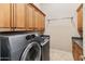 Laundry room with washer, dryer, cabinets and a utility sink at 42405 N Anthem Creek Dr, Anthem, AZ 85086