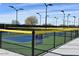 Ground-level view of several enclosed pickleball courts with fencing and lighting at 42405 N Anthem Creek Dr, Anthem, AZ 85086