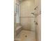 Large walk-in shower with tiled walls and a built-in seat at 42405 N Anthem Creek Dr, Anthem, AZ 85086