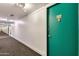 Building hallway with teal door and carpeting at 4750 N Central Ave # A3, Phoenix, AZ 85012