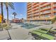 Inviting pool area with lounge chairs, palm trees, and a shaded gazebo at 4750 N Central Ave # A3, Phoenix, AZ 85012