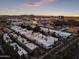 A high aerial view captures the community, complete with the city skyline and mountain range on the horizon at 4825 N 72Nd Way, Scottsdale, AZ 85251