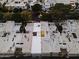 Birds-eye view of rooftops showing yellow window. Spotlights illuminate trees in the well-maintained community at 4825 N 72Nd Way, Scottsdale, AZ 85251