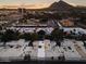 Sunset aerial view of homes and community with mountain views, highlighting the neighborhood's beautiful setting at 4825 N 72Nd Way, Scottsdale, AZ 85251