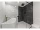 Modern bathroom with a freestanding tub, glass shower, and herringbone tile flooring at 4825 N 72Nd Way, Scottsdale, AZ 85251