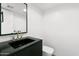 Modern bathroom with black vanity and gold fixtures at 4825 N 72Nd Way, Scottsdale, AZ 85251