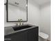 Stylish bathroom with a black vanity, modern fixtures, and a minimalist design at 4825 N 72Nd Way, Scottsdale, AZ 85251