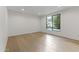 Bright bedroom with hardwood floors, white walls, and a large window at 4825 N 72Nd Way, Scottsdale, AZ 85251