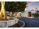 Inviting property entrance with a secure gate, lush landscaping, and exterior lighting at 4825 N 72Nd Way, Scottsdale, AZ 85251