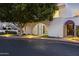 Inviting property entrance with an arched gate, wrought iron door, and lush landscaping at 4825 N 72Nd Way, Scottsdale, AZ 85251