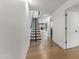 Modern hallway featuring hardwood floors, floating staircase, and ample natural light at 4825 N 72Nd Way, Scottsdale, AZ 85251