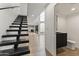 Modern hallway featuring sleek floating stairs, light wood floors, and a convenient powder room at 4825 N 72Nd Way, Scottsdale, AZ 85251