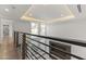 Upstairs hallway featuring modern railings, lots of natural light, and a sleek fireplace at 4825 N 72Nd Way, Scottsdale, AZ 85251