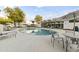 Community pool surrounded by lounge chairs and tables, set against a modern building with unique architecture at 4825 N 72Nd Way, Scottsdale, AZ 85251