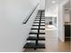 Modern floating staircase with black metal accents at 4825 N 72Nd Way, Scottsdale, AZ 85251