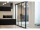 Modern floating staircase detail with black treads and an outside view from the sliding door in background at 4825 N 72Nd Way, Scottsdale, AZ 85251