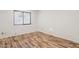 Bright bedroom with laminate wood flooring and a window at 4842 E Surrey Ave, Scottsdale, AZ 85254