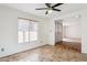 Bright dining area with tile flooring, ceiling fan and view to entryway at 4842 E Surrey Ave, Scottsdale, AZ 85254