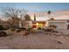 Attractive single-story home with desert landscaping and red front door at 4842 E Surrey Ave, Scottsdale, AZ 85254